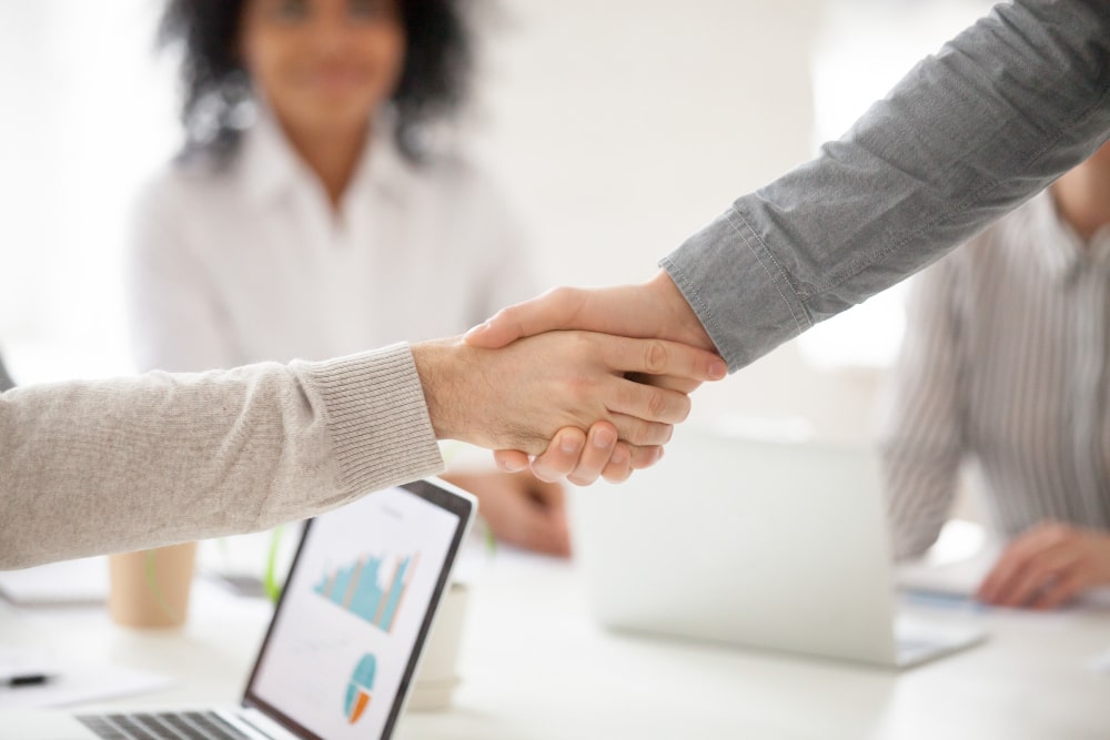 business-partners-handshaking-group-meeting-making-project-investment-closeup-min